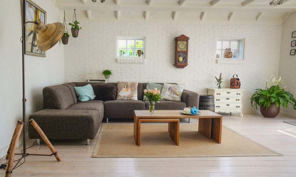 Renting a Home or Home-Sharing on Airbnb? Short-Term Rental Insurance Insights - Minimal Living Room Apartment With White Brick Walls and a Sectional Sofa